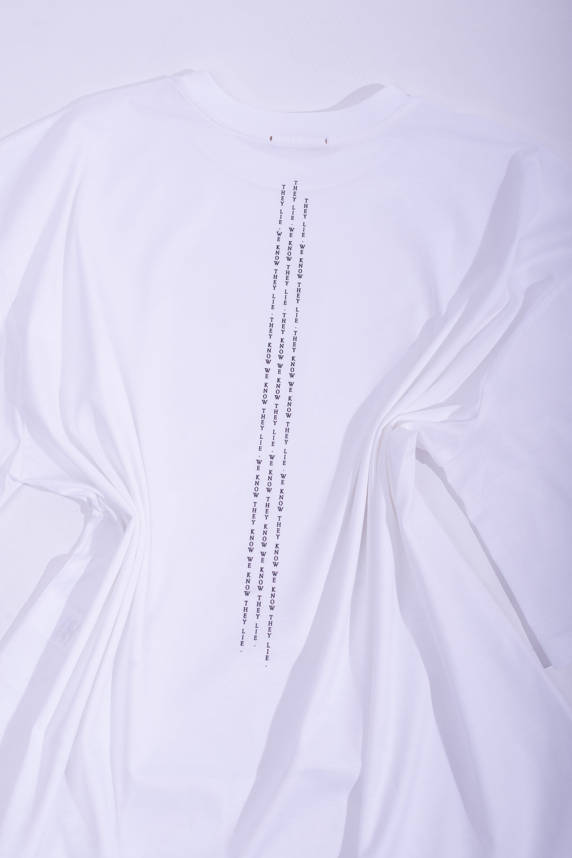 White cotton jersey ''THEY LIE'' boxy t-shirt